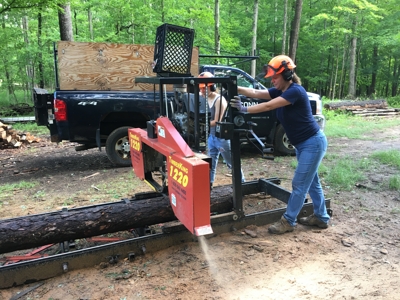 woman working the UConn sawmill in the forest