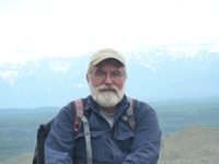 picture of professor with mountain in background