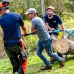 Forest crew hauling a log with an arch